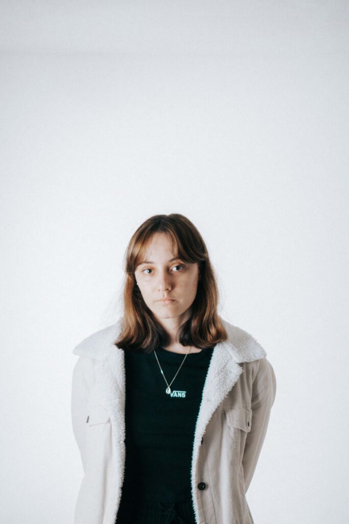 Portrait of woman with vans shirt and denim jacket