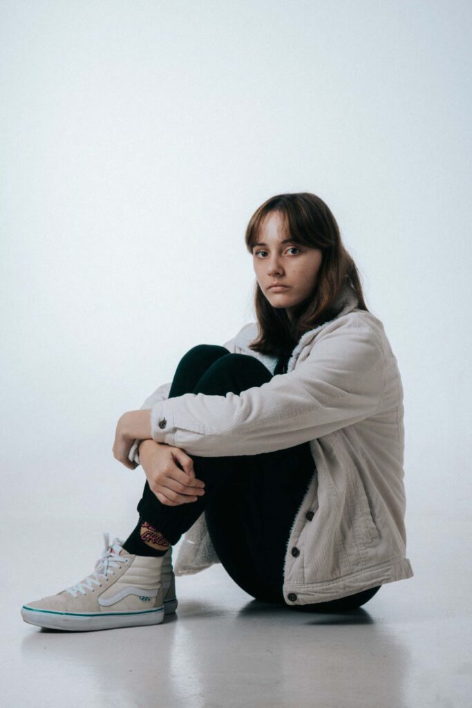 Woman wearing Vans Sitting on Floor