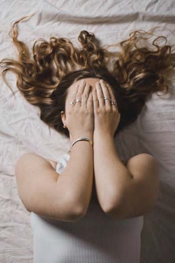 Girl covering face with golden hair