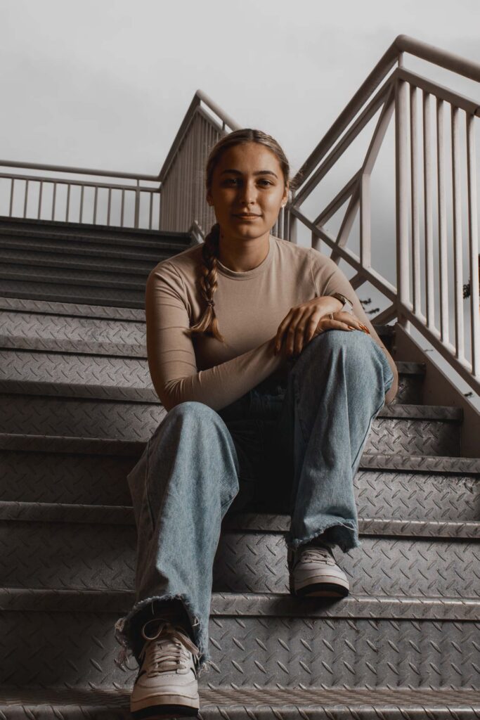 woman on stairs sitting up